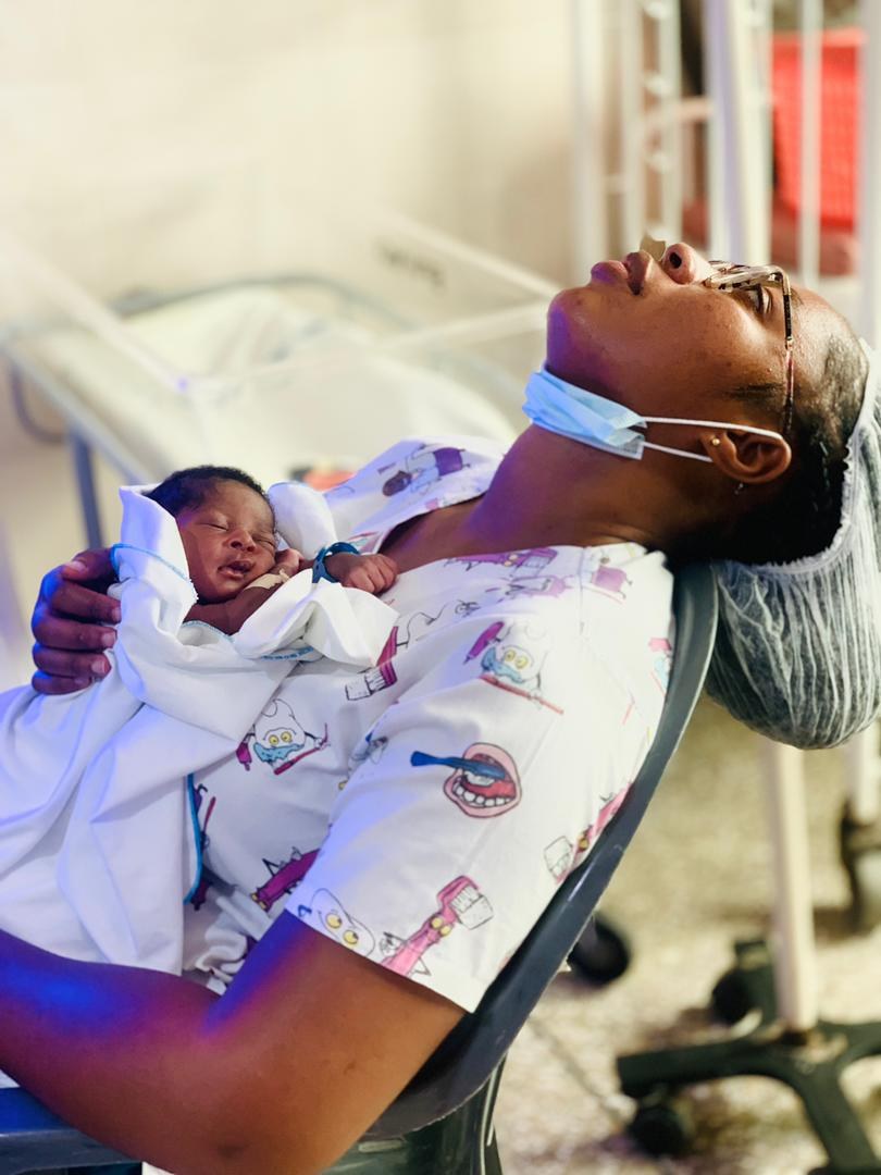 African midwife attending a mother and newborn (illustrative image)