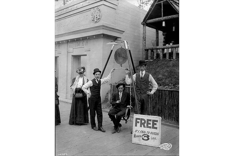 Historic photograph of a carnival ‘Guess Your Weight’ game (Seattle, 1909) — image does not illustrate WHO child and adolescent obesity guidelines and no suitable illustrative image was provided in the source.