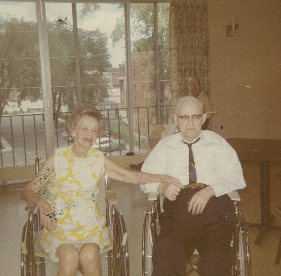 Relatives visiting elderly residents at an old age home, black-and-white family photo